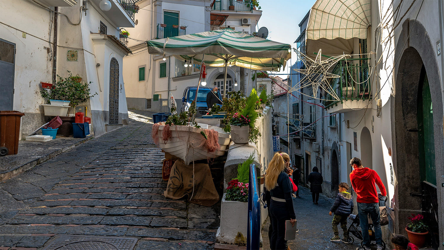 Steep cobbled street with local homes and pedestrians in Vietri sul Mare