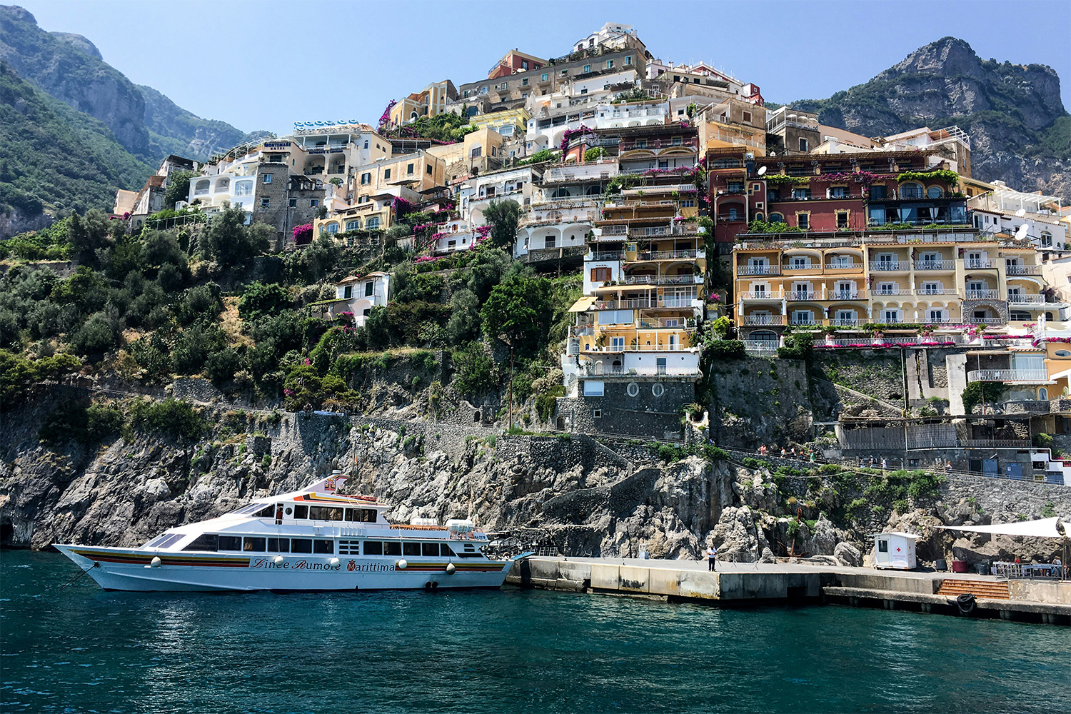 Ferry arriving at Positano beneath the hillside town on the Amalfi Coast.