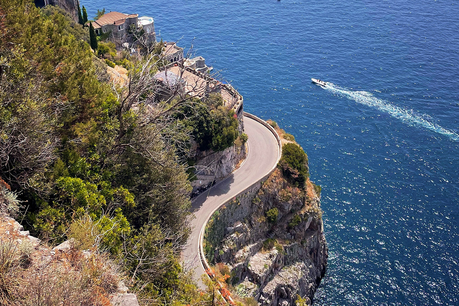 Winding coastal road above the Mediterranean Sea on the Amalfi Coast.