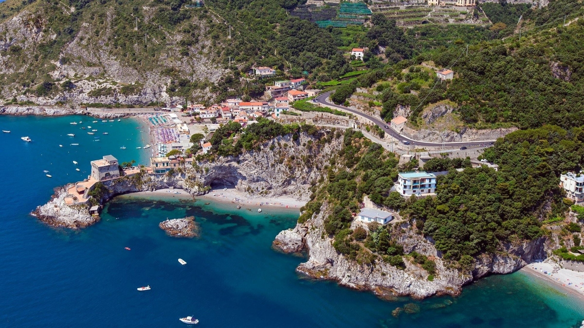 Aerial view of Erchie Beach with turquoise coves, rocky coastline and the coastal road on the Amalfi Coast
