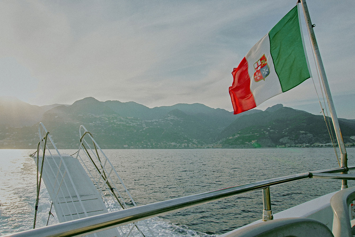 Ferry boat on the Amalfi Coast with an Italian maritime flag.